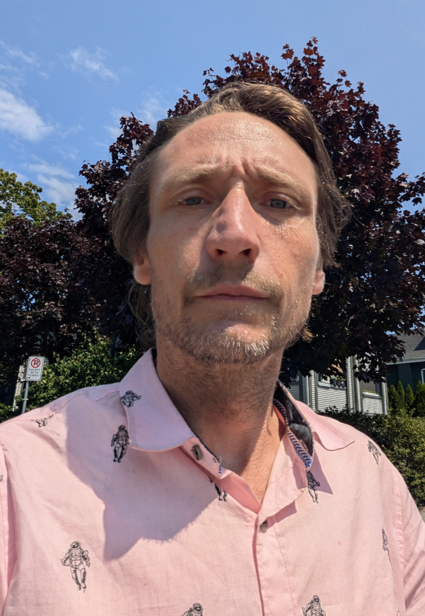 Portrait of Scott Gilbert outdoors in a pink shirt